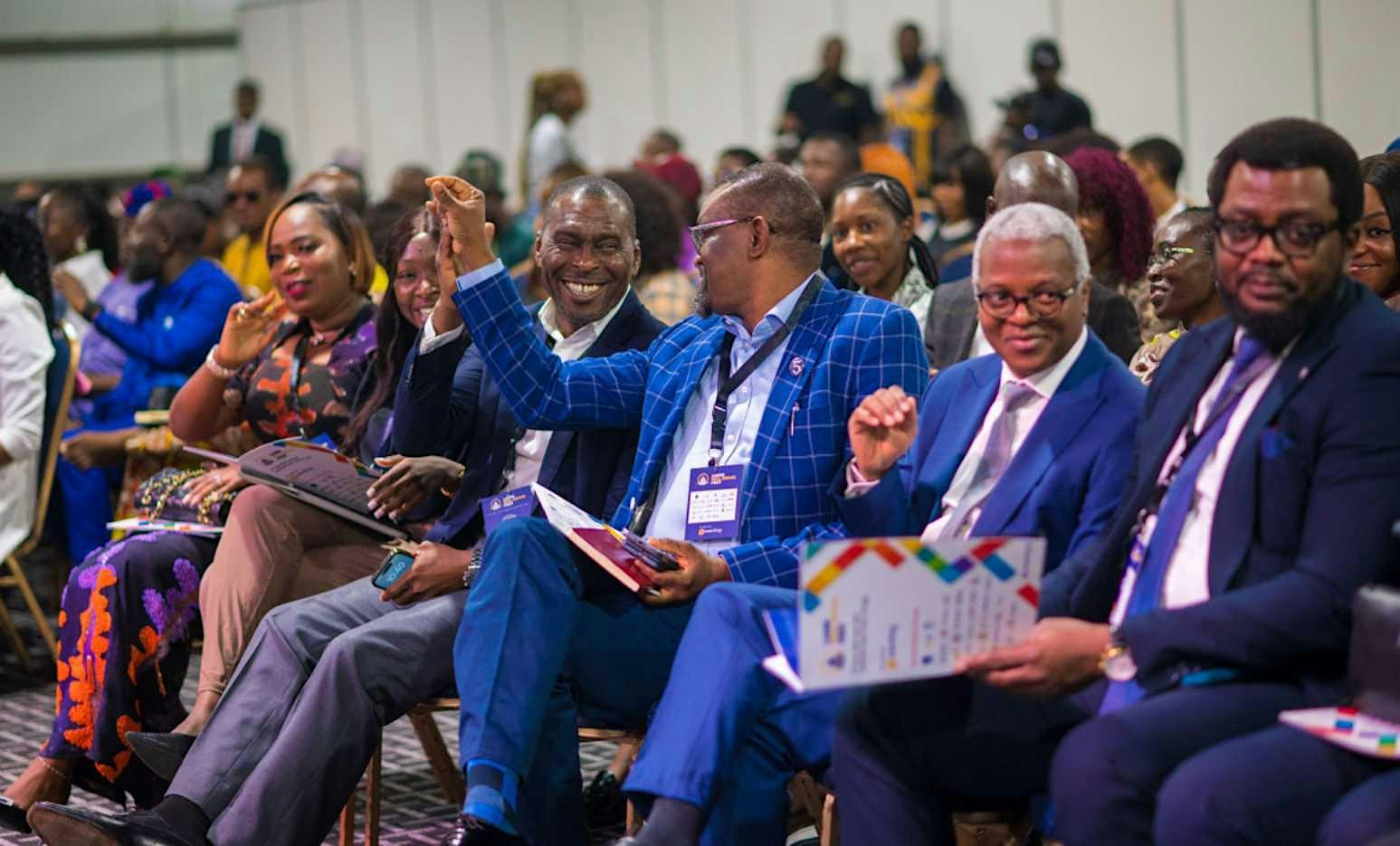 Conference delegates sharing a lively moment in the front row